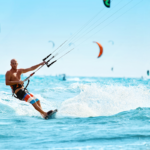 A surfer rides a wave at a beach.