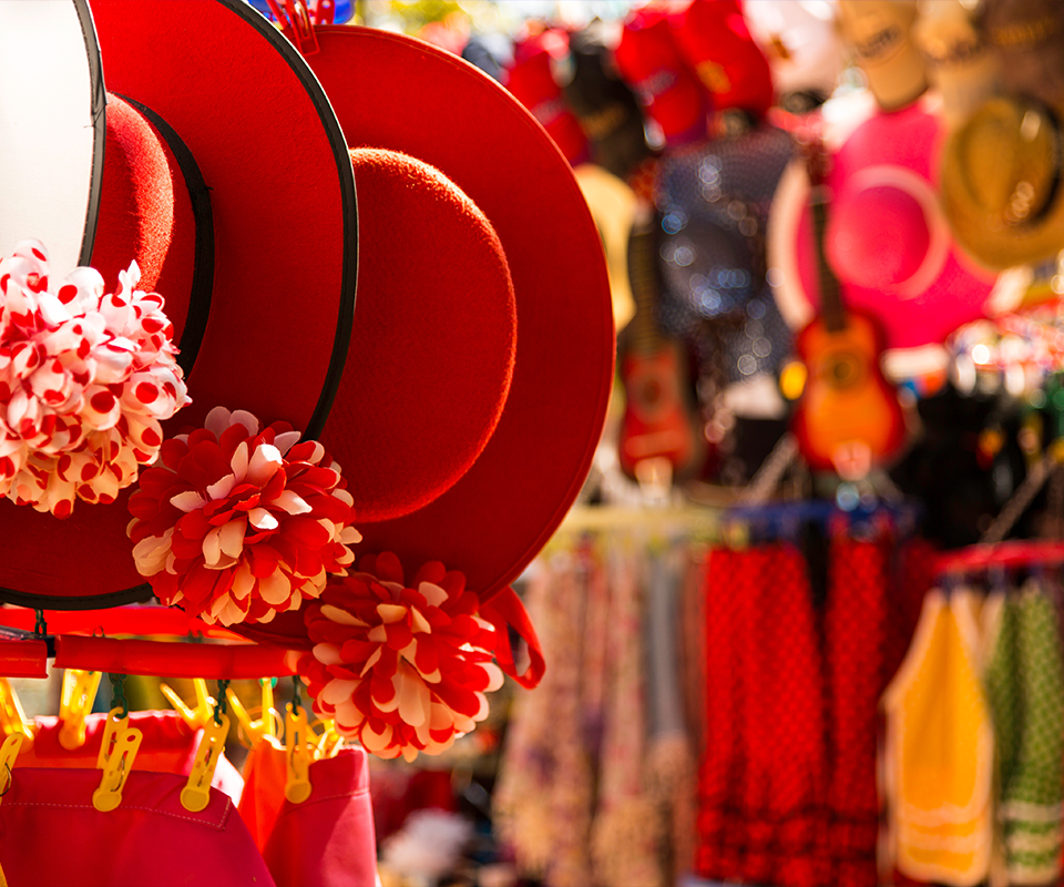 A lively market scene in Phuket at night with stalls filled with traditional crafts and souvenirs.