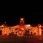 Phuket's vibrant Sino-Portuguese building illuminated at night, showcasing its colorful architecture against the evening sky.