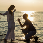 A man proposing to his partner at sunset on a romantic beach in Phuket, Thailand, with a stunning sea view.