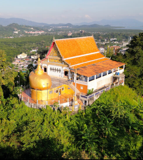 Aerial view of Wat Koh Sirey temple surrounded by lush greenery in Phuket, Thailand.