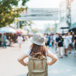 o female traveler exploring a busy Thai market, representing the experience of wondering, “Is Phuket safe?” for visitors and residents