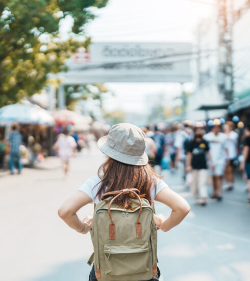 o female traveler exploring a busy Thai market, representing the experience of wondering, “Is Phuket safe?” for visitors and residents